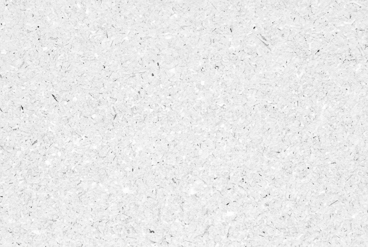 Textured white paper background with natural fibers and small speckles, ideal for design, crafts, or as a texture element. photo