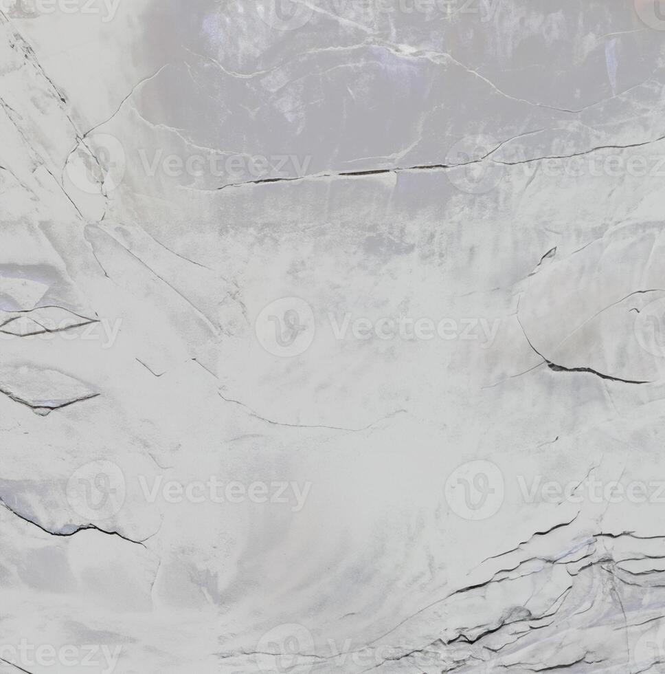 Close-up of a textured stone surface with natural cracks and a soft gradient, ideal for backgrounds and textures. photo