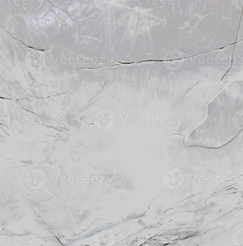 Close-up of a textured stone surface with natural cracks and a soft gradient, ideal for backgrounds and textures. photo