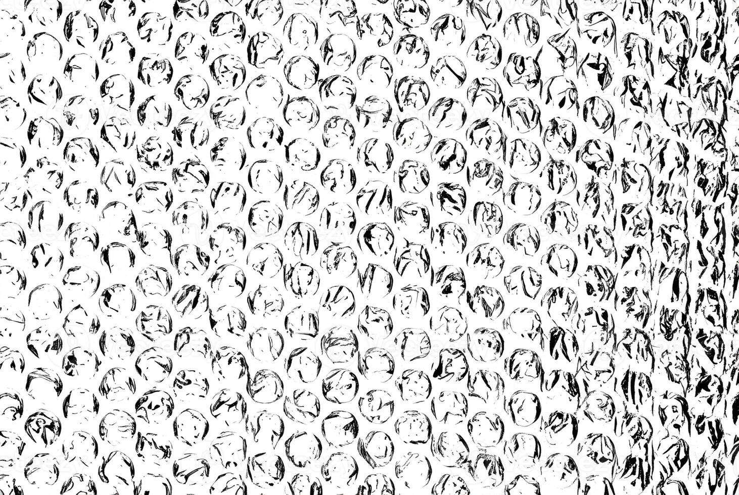 High-contrast black and white bubble wrap texture, featuring circular patterns and crinkled details. photo