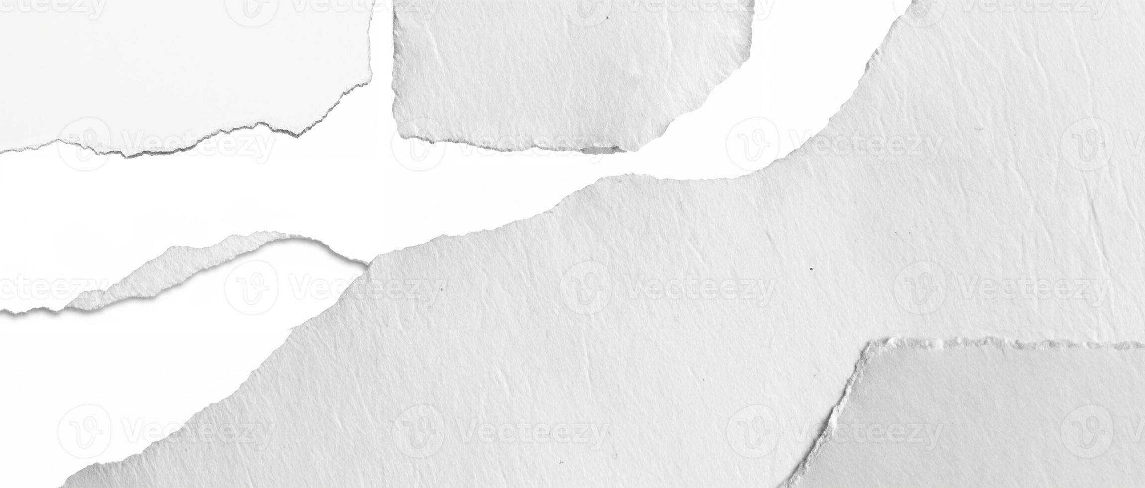 Close-up of a torn white paper edge with a textured surface, ideal as a background or overlay. photo