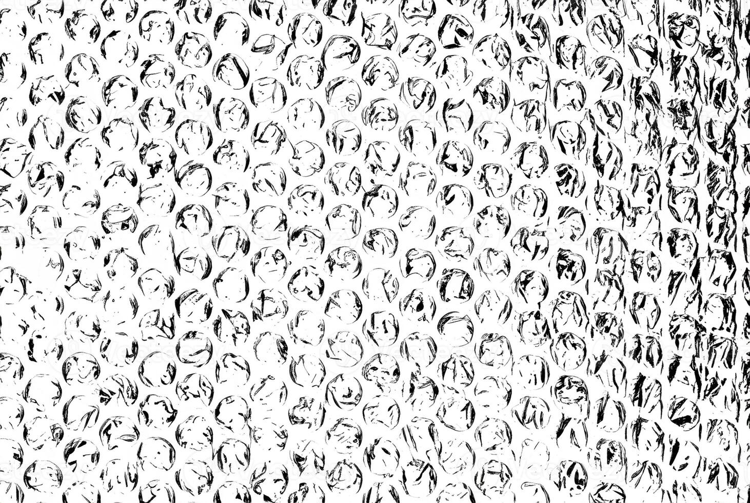 High-contrast black and white bubble wrap texture, featuring circular patterns and crinkled details. photo