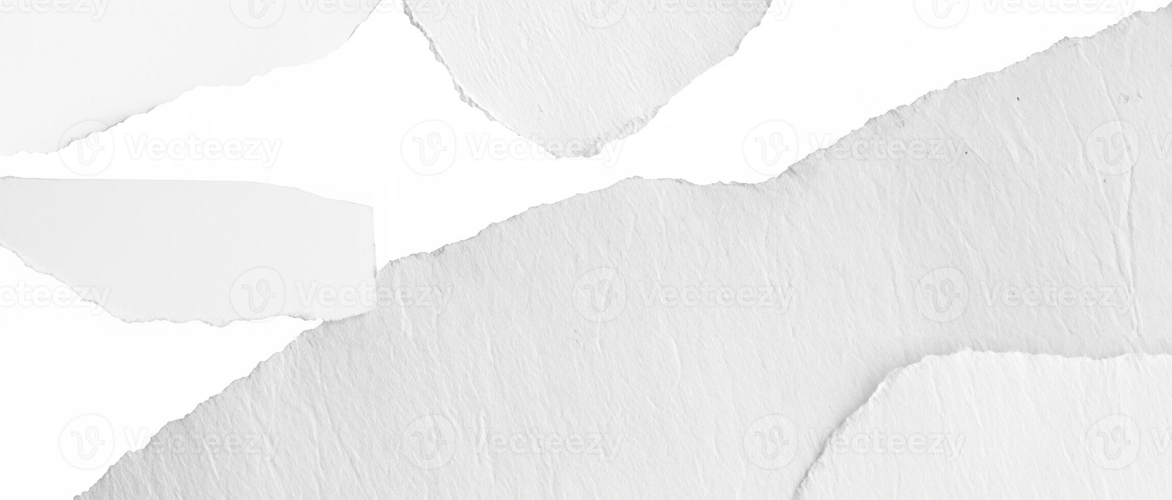 Close-up of a torn white paper edge with a textured surface, ideal as a background or overlay. photo