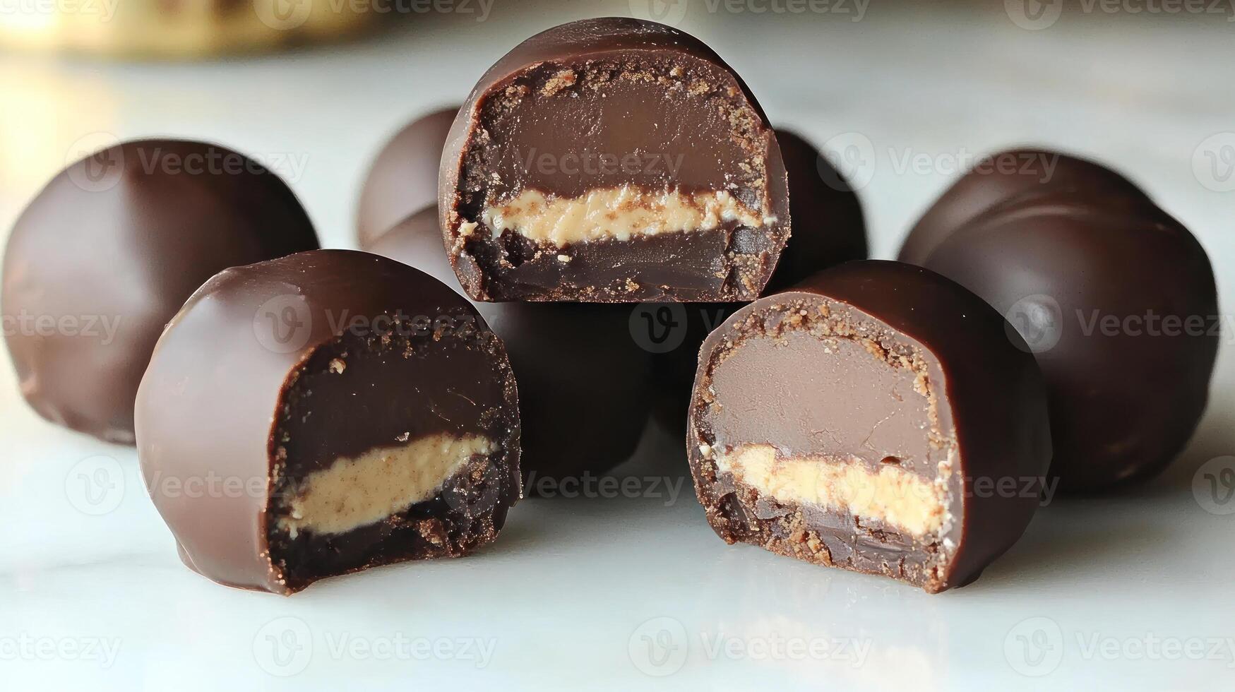 Delicious chocolate truffles reveal a rich peanut butter filling, enticing all around photo
