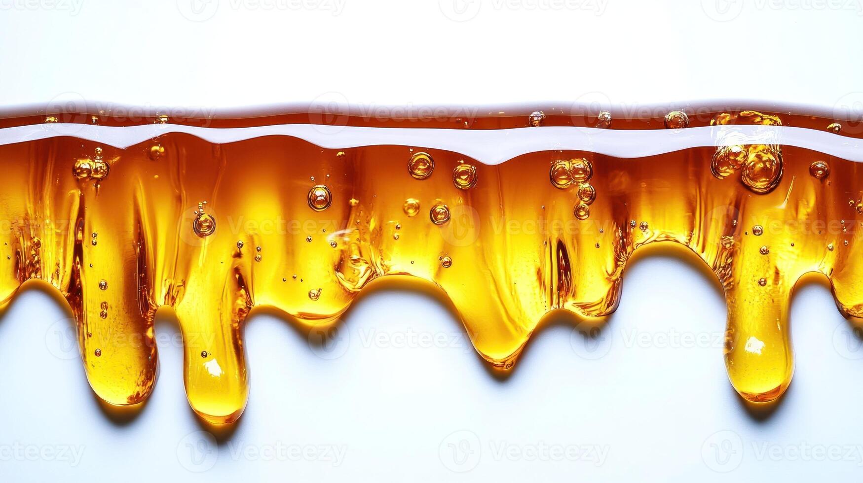 Rich, golden honey oozes and glistens, creating a beautiful, textured flow photo