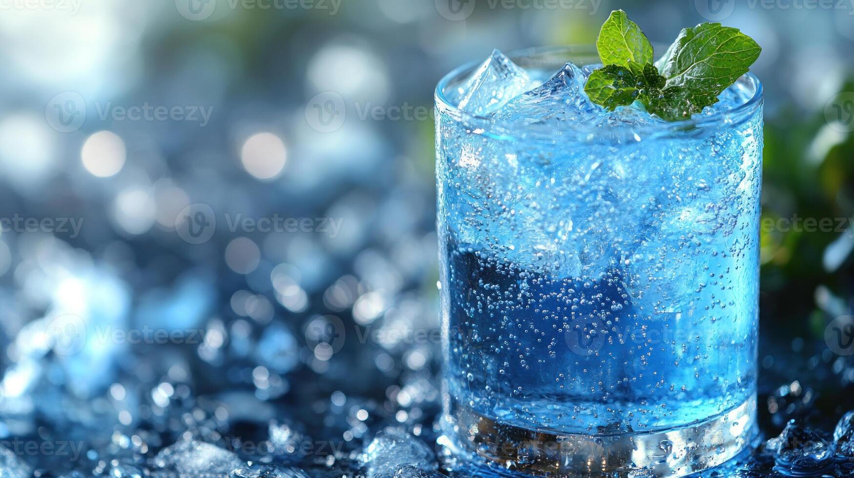 A sparkling blue drink sits atop crushed ice, beautifully adorned with fresh mint photo