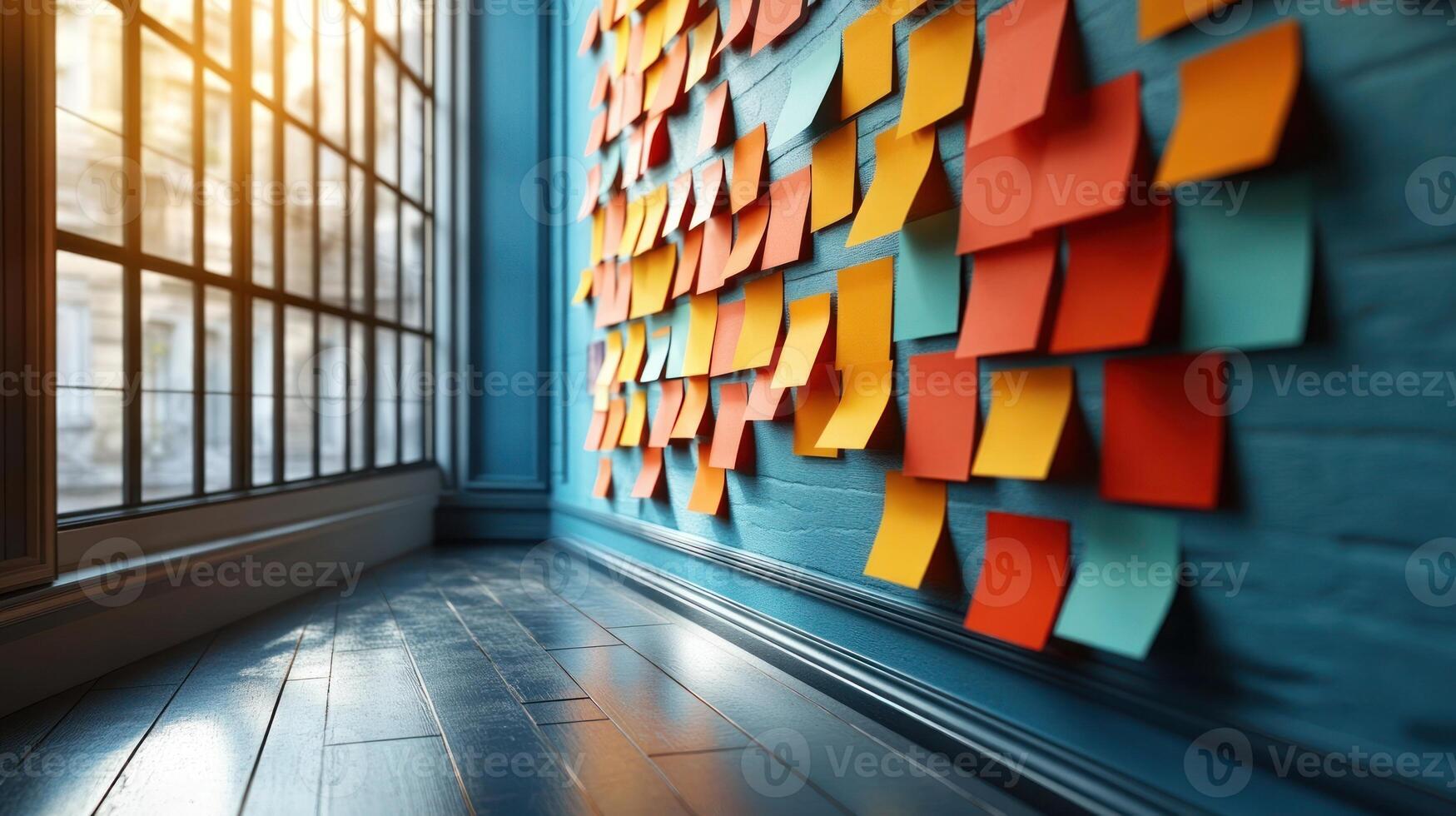 Vibrant sticky notes cover a wall, reflecting creativity in a bright, open office photo