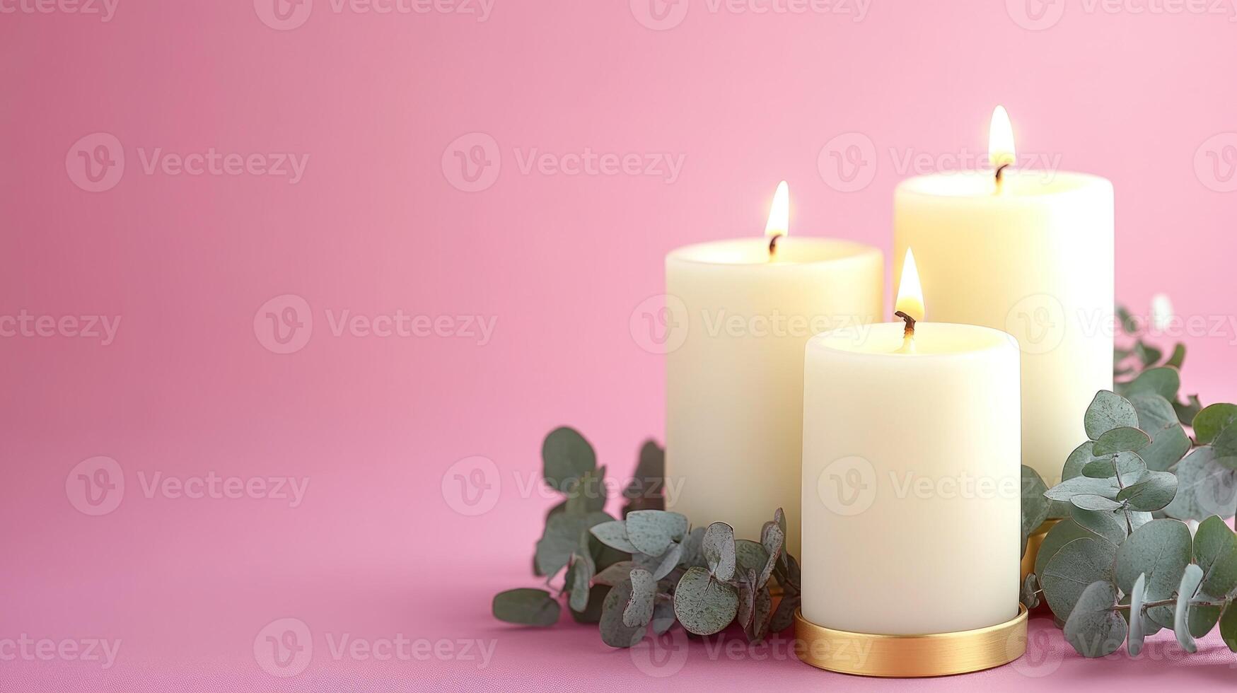 Three candles illuminate a calming atmosphere, surrounded by fresh eucalyptus leaves photo