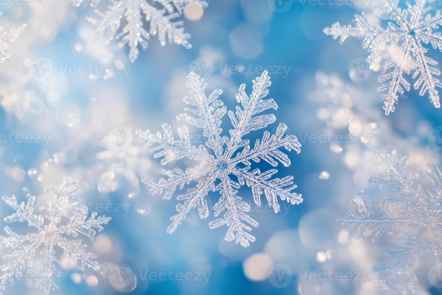 An enchanting and mesmerizing display of intricate snowflakes gracefully set against a dreamy blue background, which evokes a deep sense of winter magic, beauty, and seasonal celebration photo