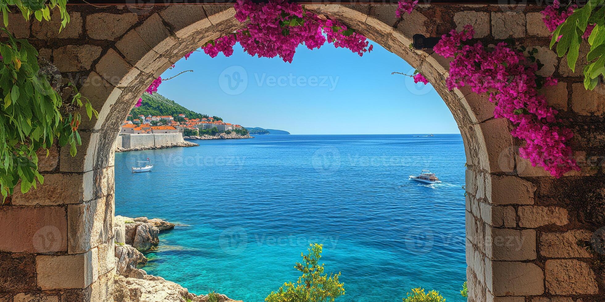 A breathtaking view of the azure sea framed by vibrant pink flowers and ancient stone architecture, epitomizing Mediterranean charm photo