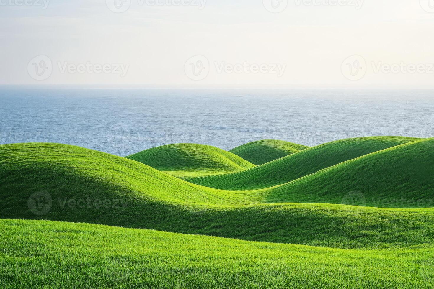 A beautifully serene landscape featuring rolling green hills that gently meet a calm ocean, perfectly embodying tranquility and showcasing the captivating beauty of nature in all its glory photo