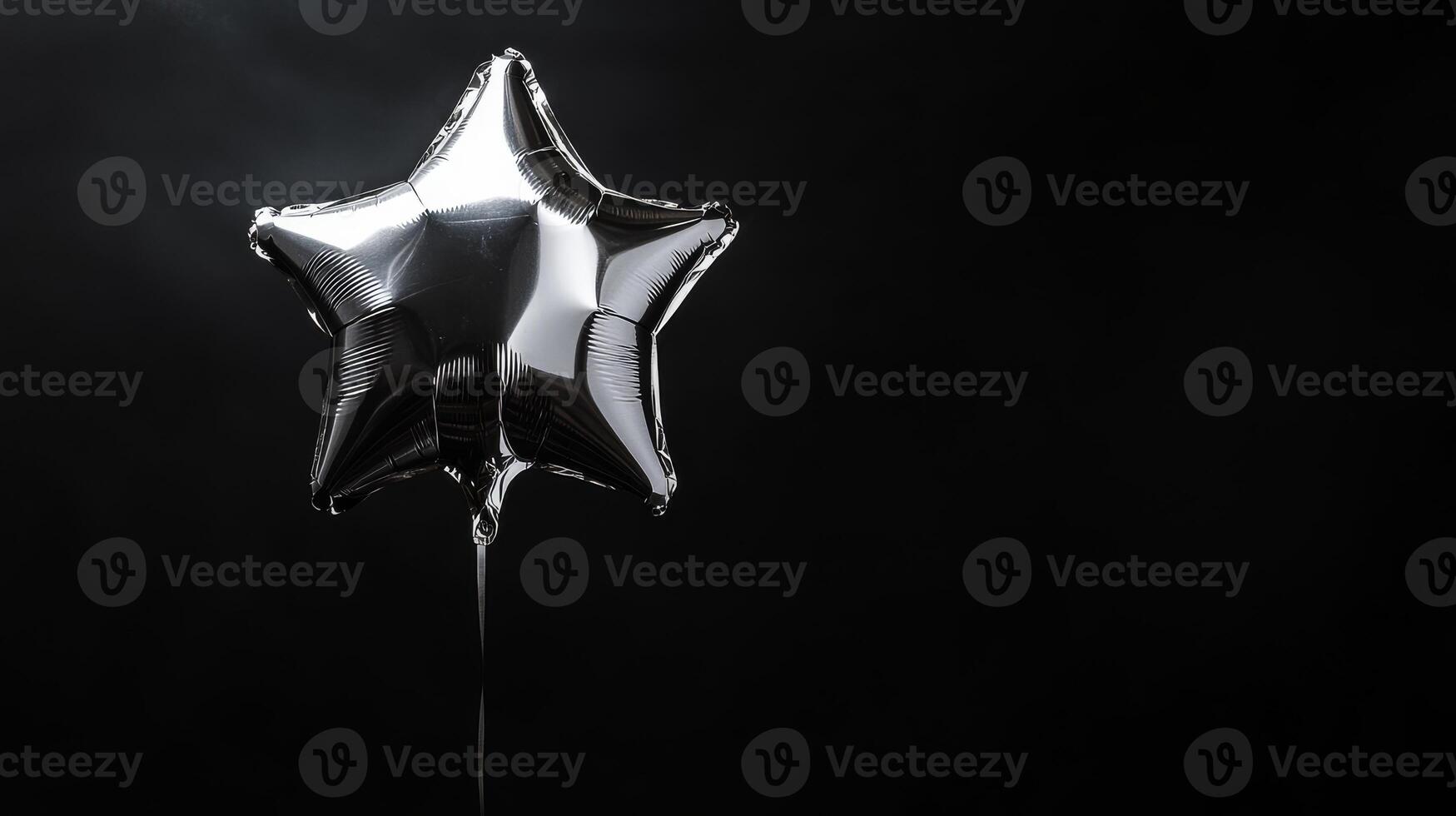 A shiny and gleaming silver starshaped balloon floats gracefully against a dark backdrop, beautifully illuminated by soft, warm light, which adds a wonderful touch of elegance and charm to the scene photo