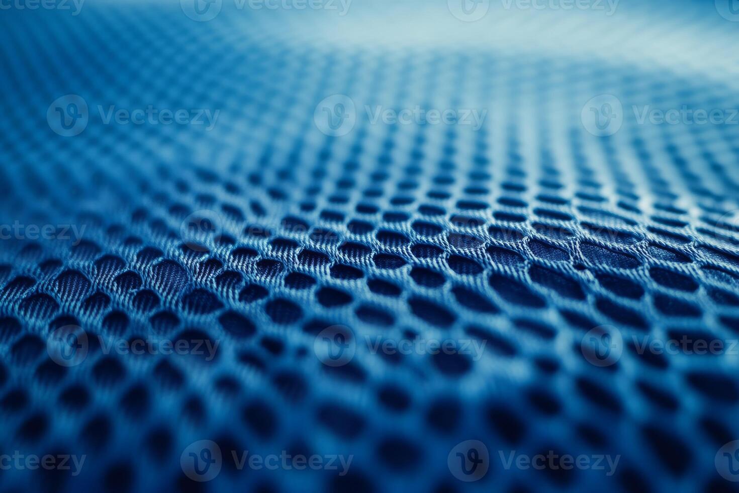 This image shows a closeup of vibrant blue fabric resembling sports jersey material. It has intricate textures, ideal for fashionable athletic wear suitable for various performance sports photo