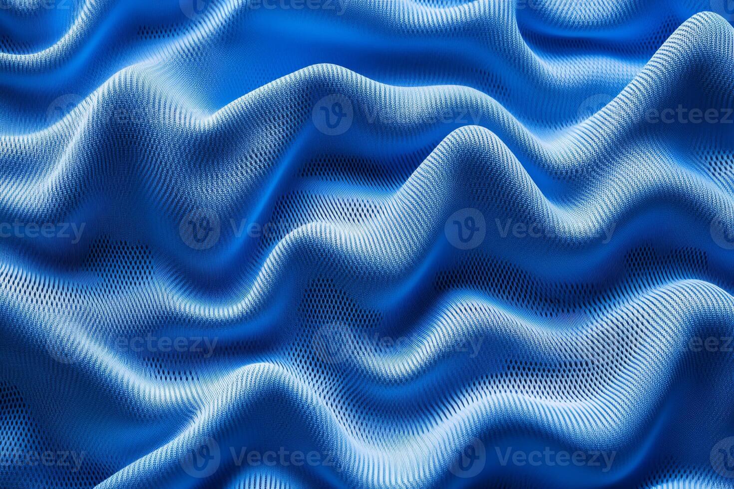 Discover a stunning blue fabric texture ideal for sports jerseys. With captivating waves that evoke dynamic movement, its an excellent choice for athletic wear and active apparel photo