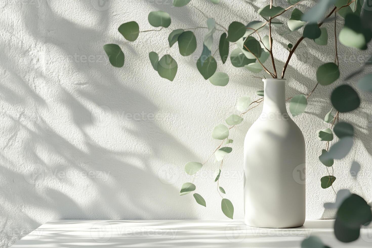 A beautiful display features a white vase filled with vibrant greenery, casting intricate shadows on a neutral background, creating elegant, eyepleasing sustainable decor that captivates the senses photo