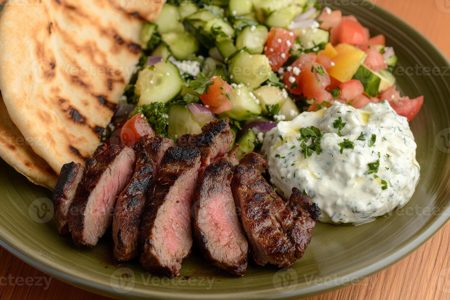 Indulge in a mouthwatering Greek lamb souvlaki plate that comes accompanied by warm pita bread, creamy tzatziki sauce, and a vibrant fresh Greek salad. Its a perfect choice for a flavorful meal photo