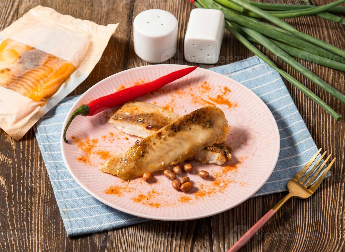 Sichuan Spicy Shufei Snapper fish with red chilli served in plate isolated on napkin side view of taiwan food photo
