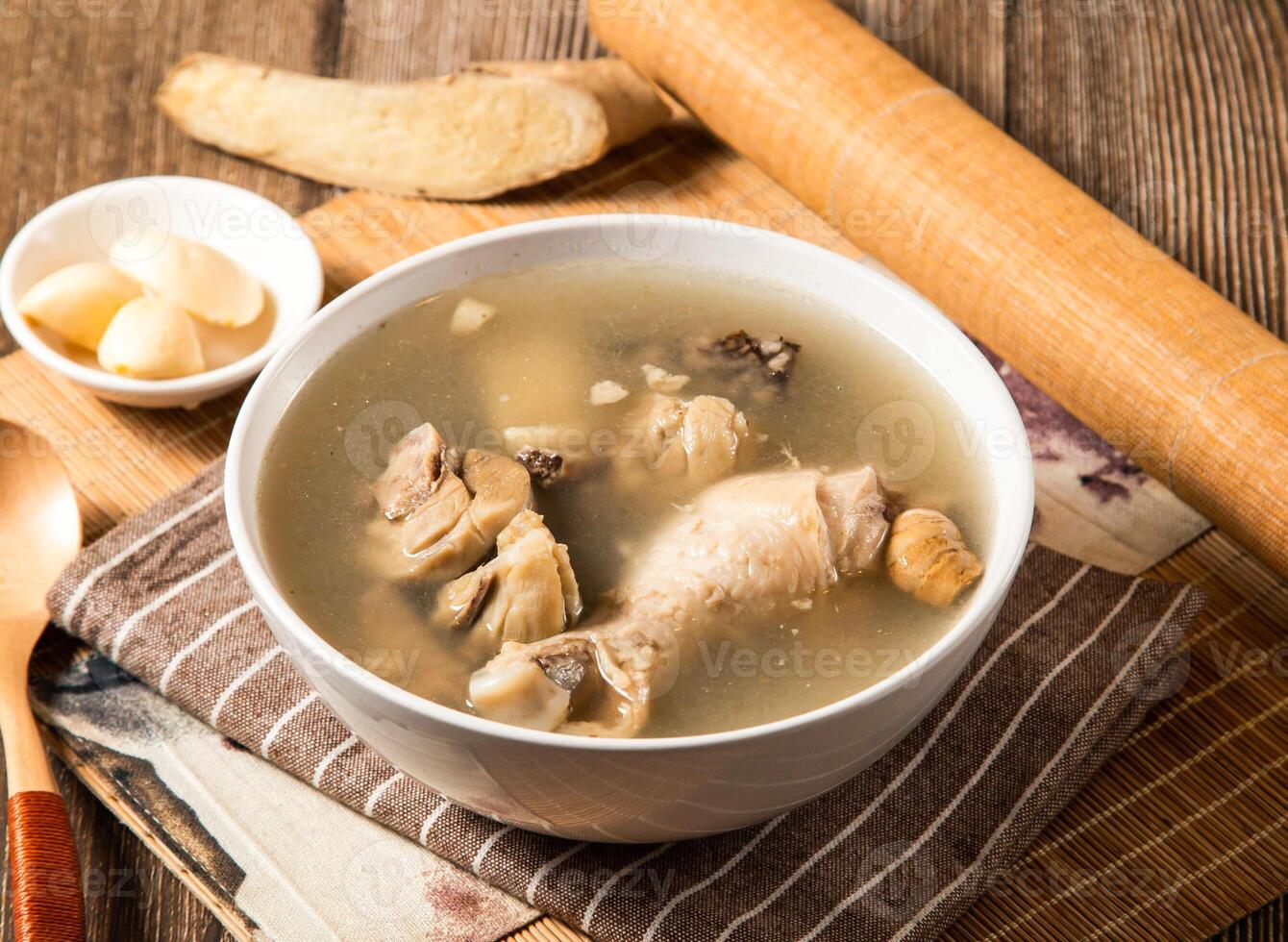 Sesame oil rice blood chicken soup with spoon served in bowl isolated on napkin side view of taiwan food photo
