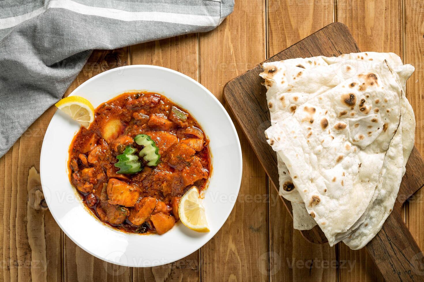 Nashif Chicken with pita bread served in plate isolate on wooden table top view of arabic food photo