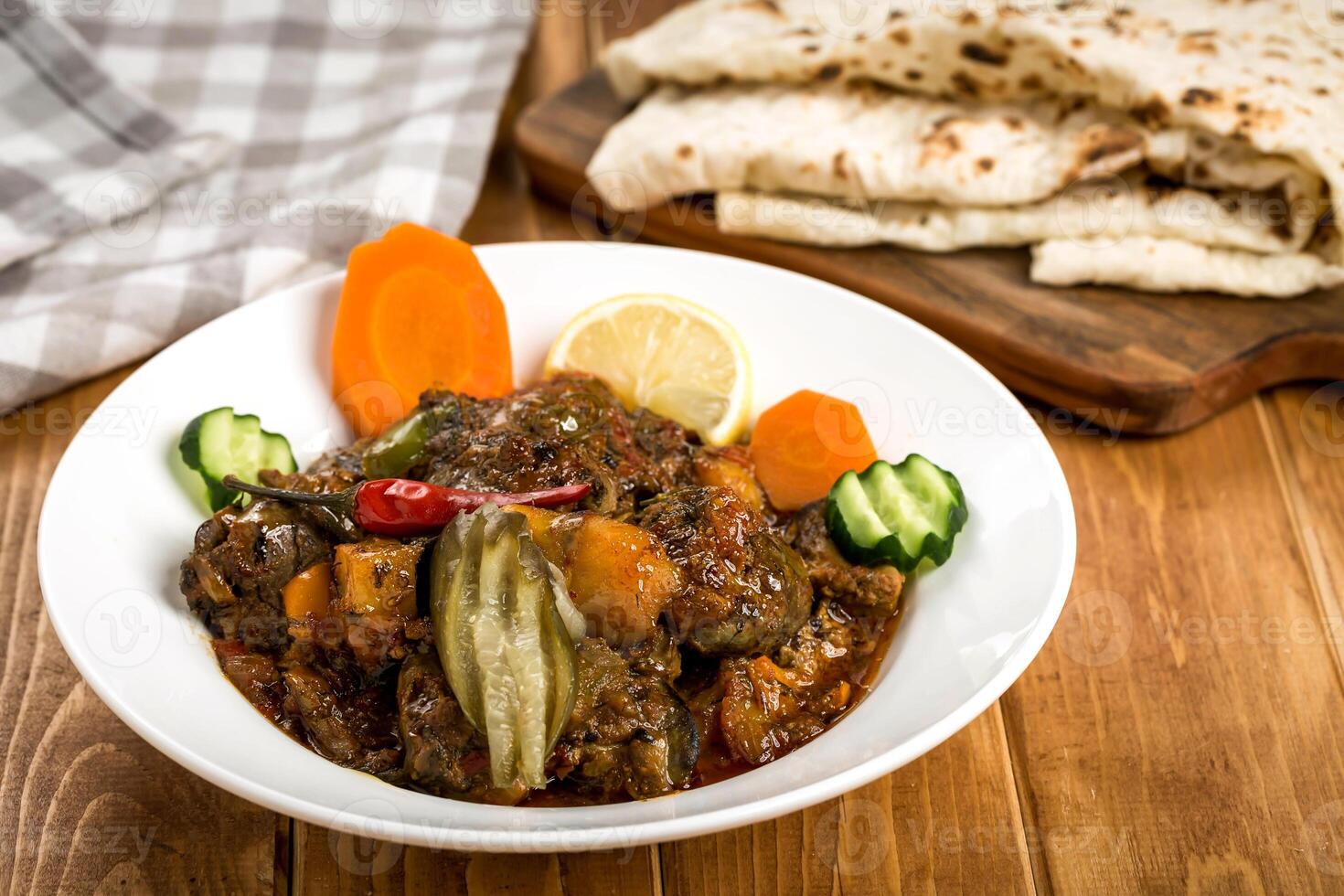 Arabic Beef liver with pita bread served in plate isolated on wooden table side view of traditional Middle Eastern food photo