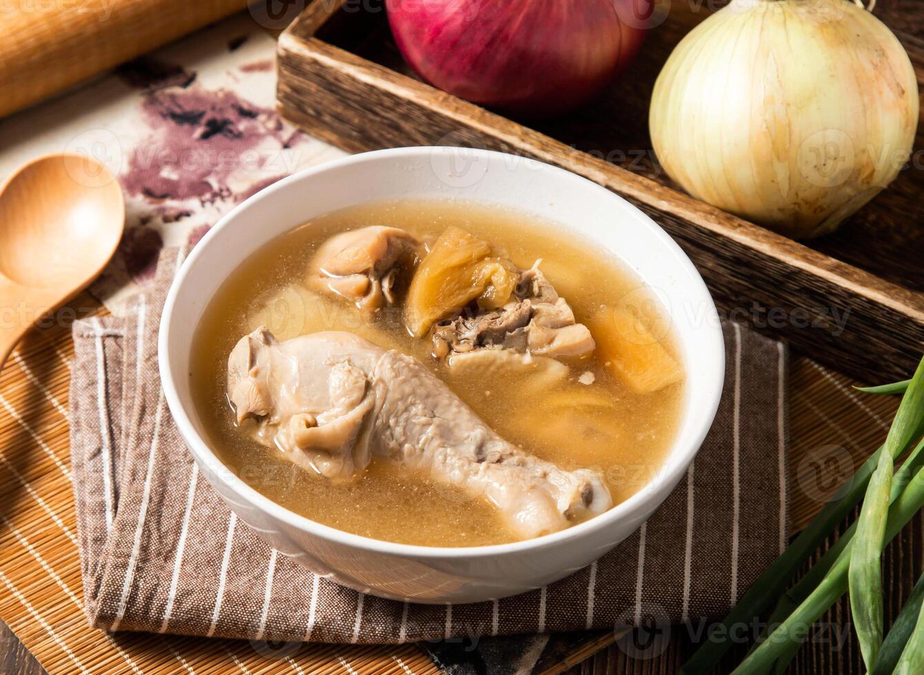 Pineapple Bitter Melon Chicken Soup with spoon served in bowl isolated on napkin side view of taiwan food photo