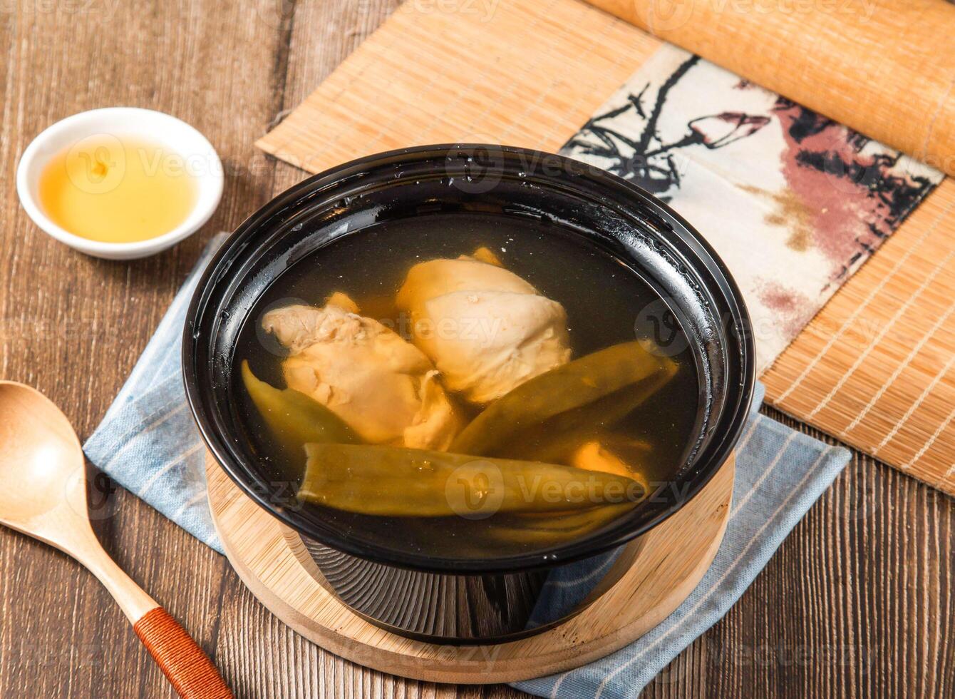 Peeled Chili Chicken Soup with spoon served in bowl isolated on napkin side view of taiwan food photo