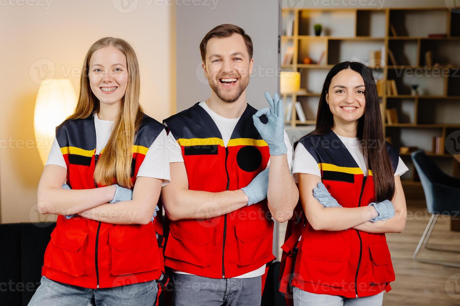 Group of people with cpr dummy looking at camera and smiling after first aid training class photo