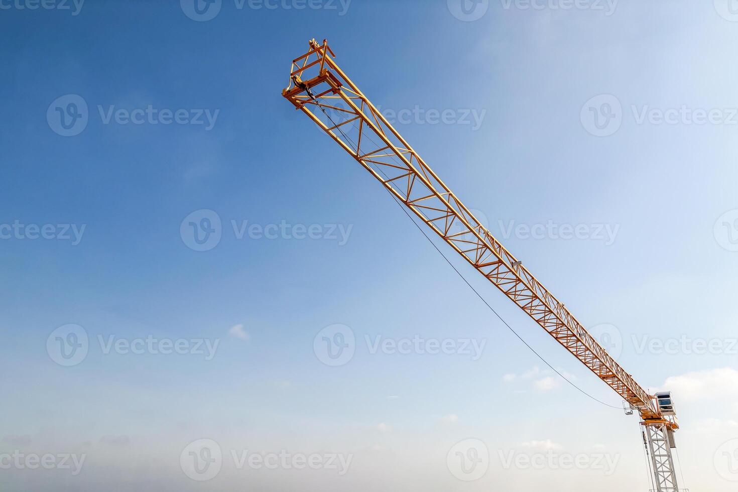 Industrial construction crane with blue sky background at building site photo