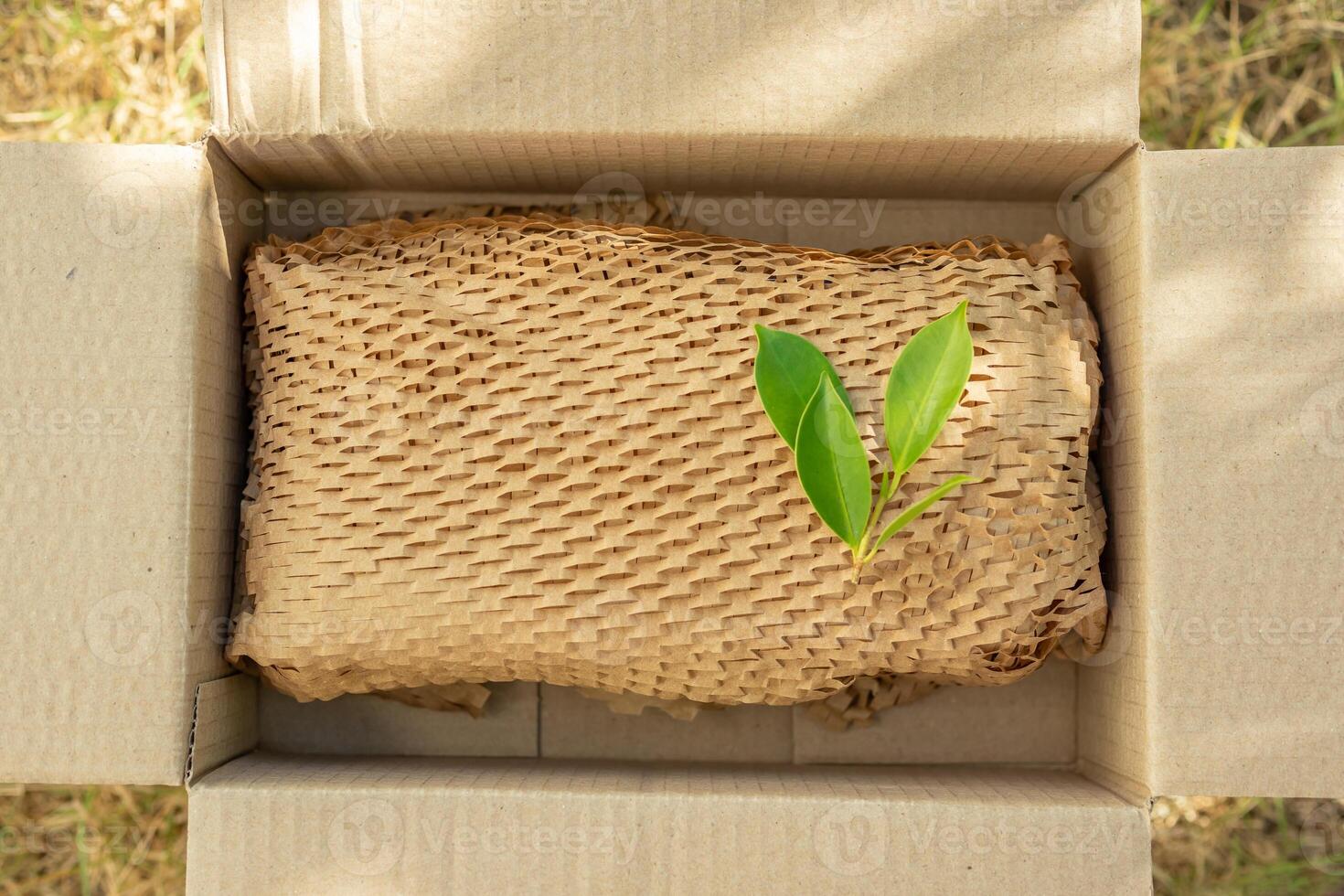 Green leaf on eco friendly brown paper honeycomb wrap for product packaging parcel carton box photo