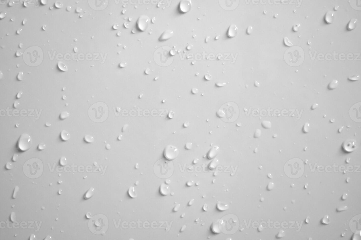 Water drops on white wall background texture photo