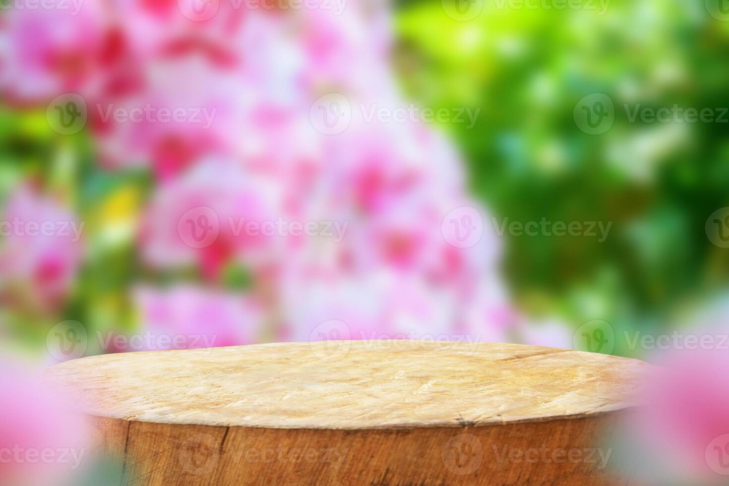 Empty old tree stump table top with blur orchid garden background for product display photo
