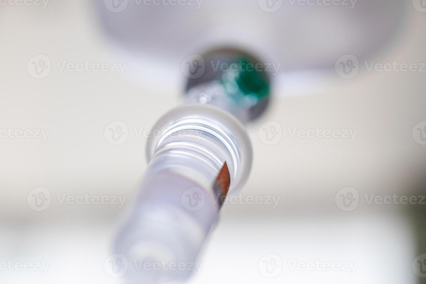 Close up medical intravenous IV drip in hospital background photo