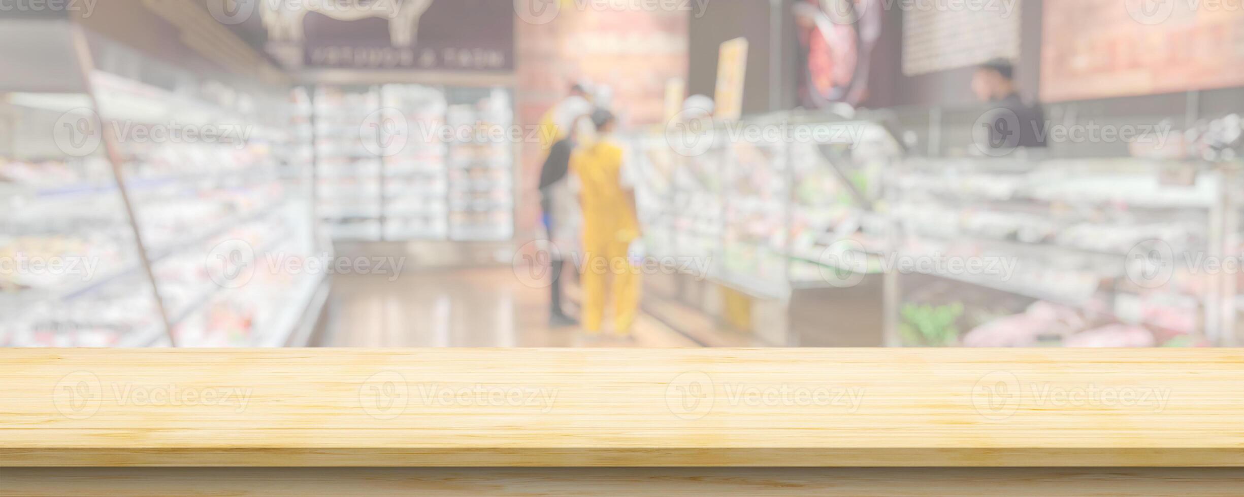 Wood table top with supermarket grocery store blurred background with bokeh light for product display photo