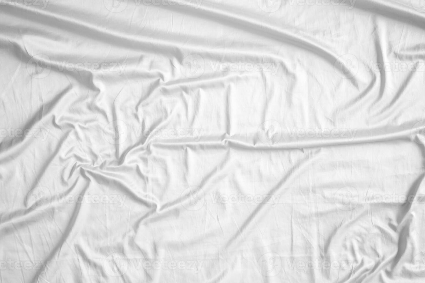 Abstract white wrinkled bedding sheet fabric texture background photo