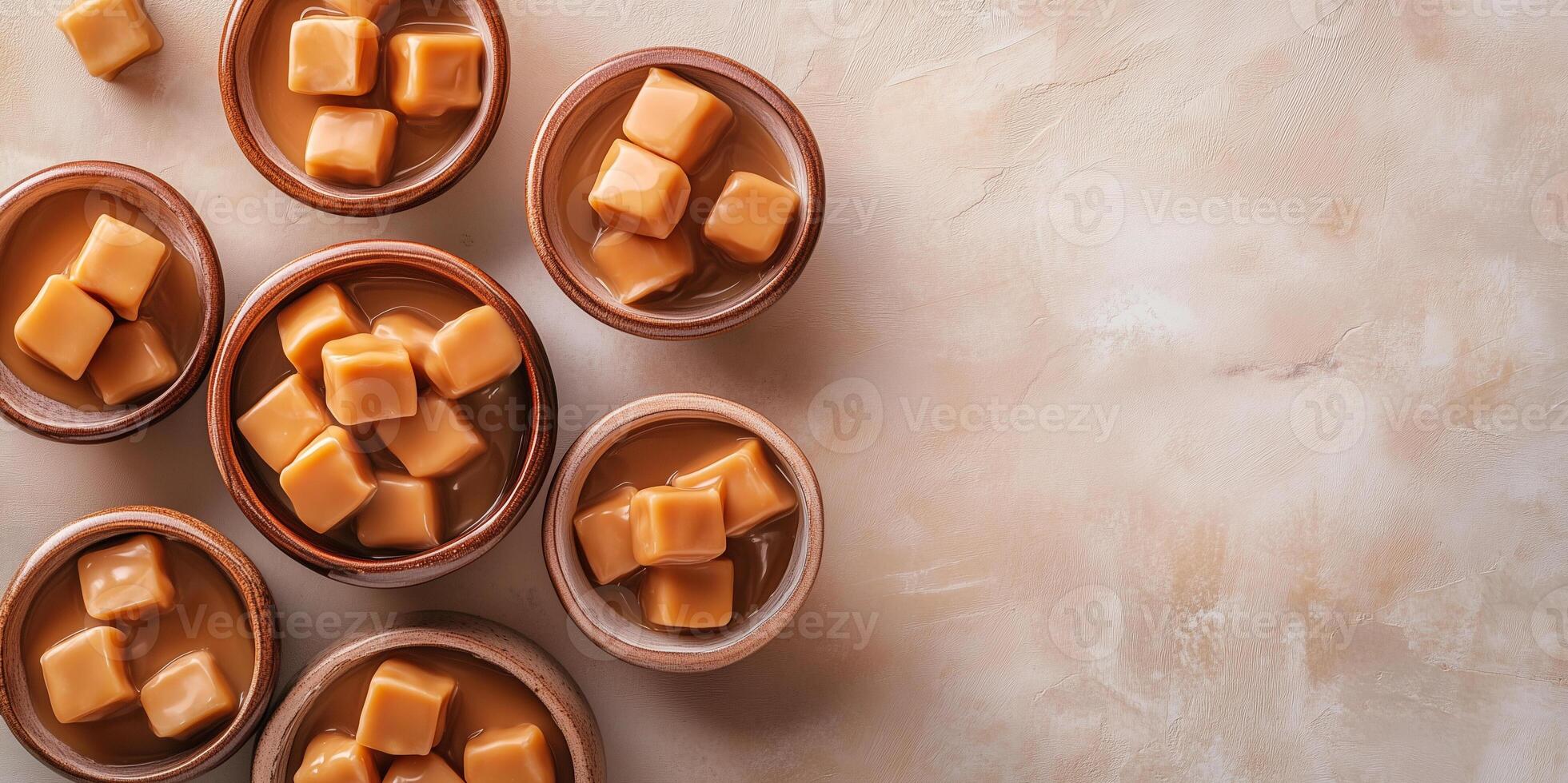 Soft caramel candies placed in decorative bowls of different shapes photo