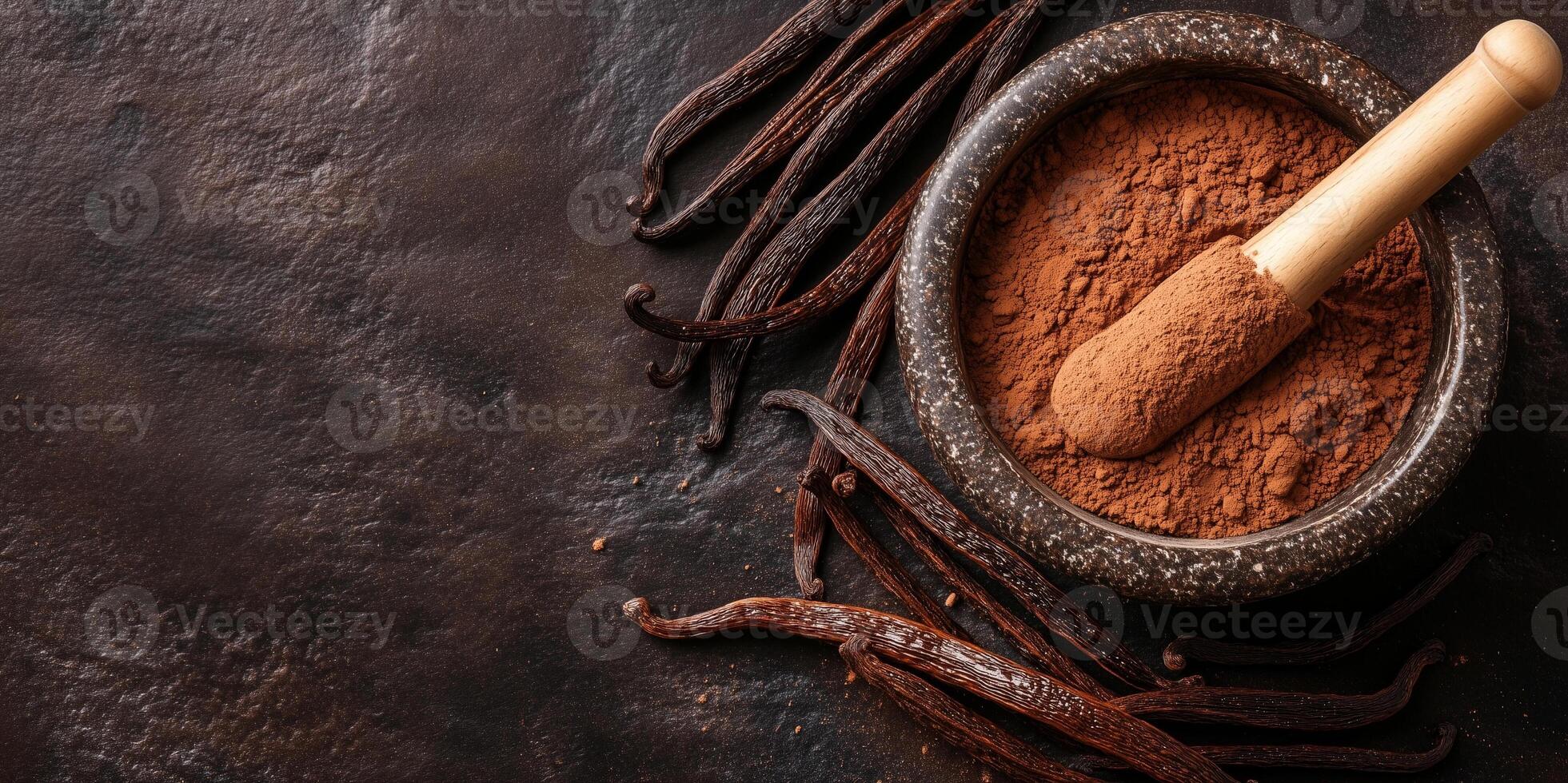 Vanilla powder in a mortar with pestle next to whole beans photo