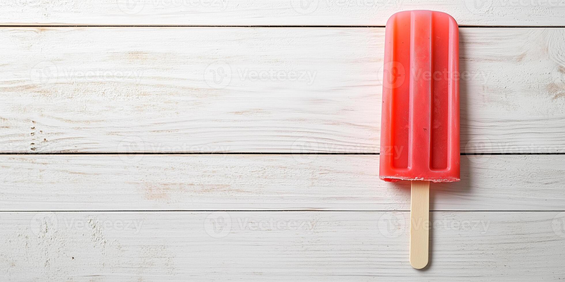 Popsicle drip catcher attachment demonstrated on wooden popsicle stick photo