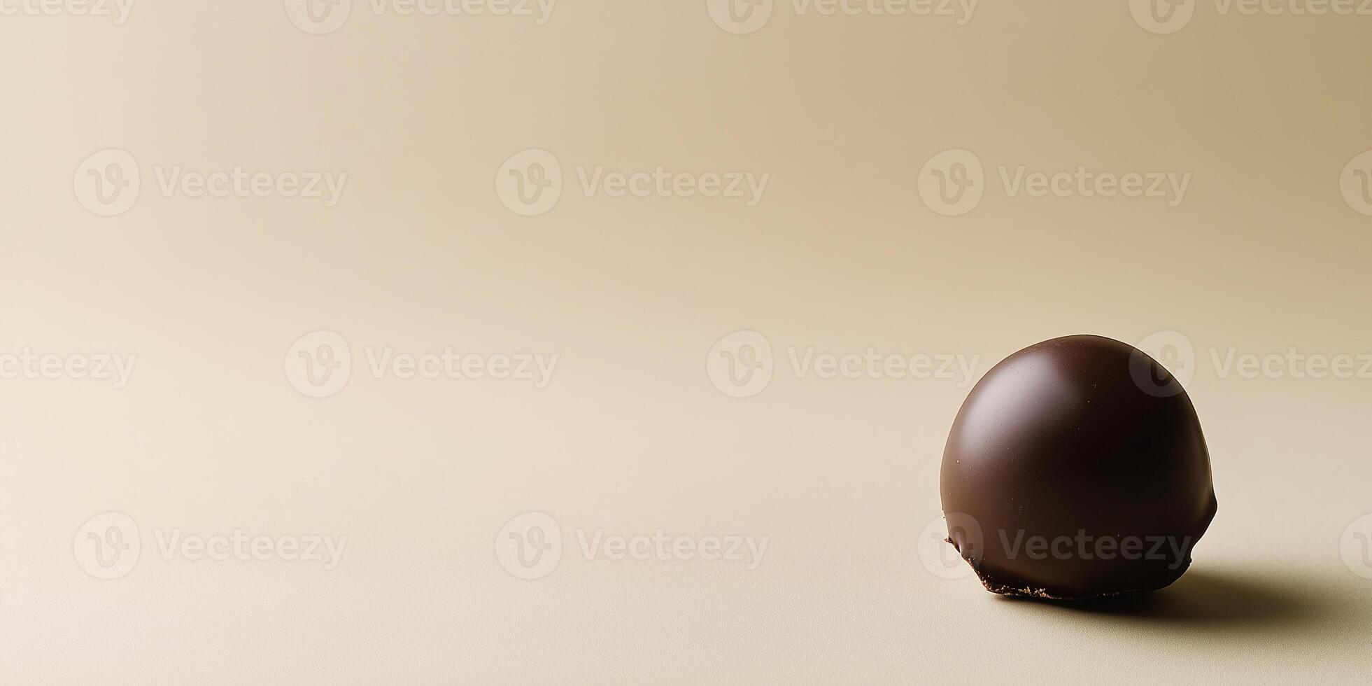 Single bonbon in the bottom right corner, contrasting with empty space above photo