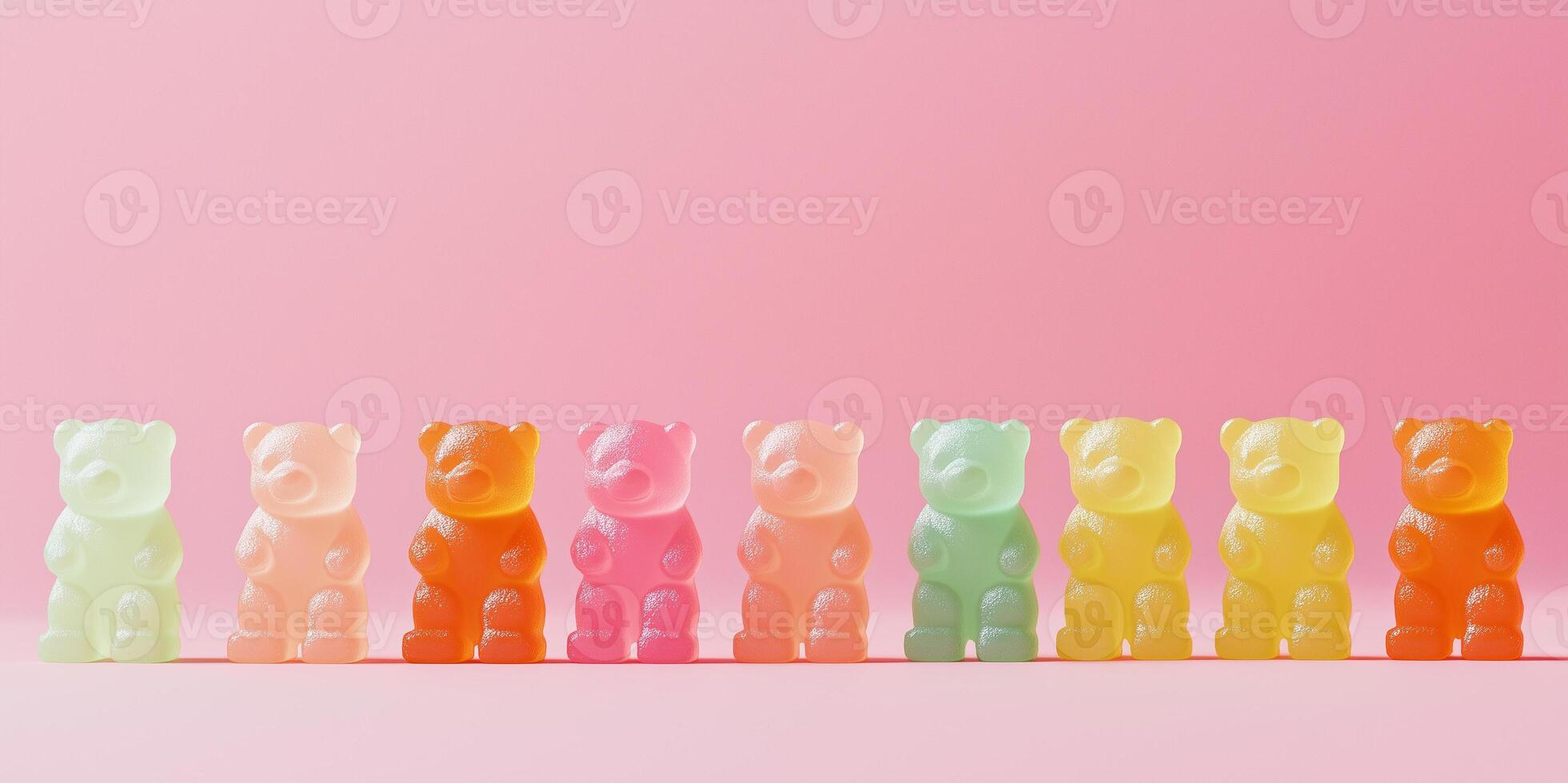 Candy pieces shaped like miniature bears lined up in rows on a surface photo