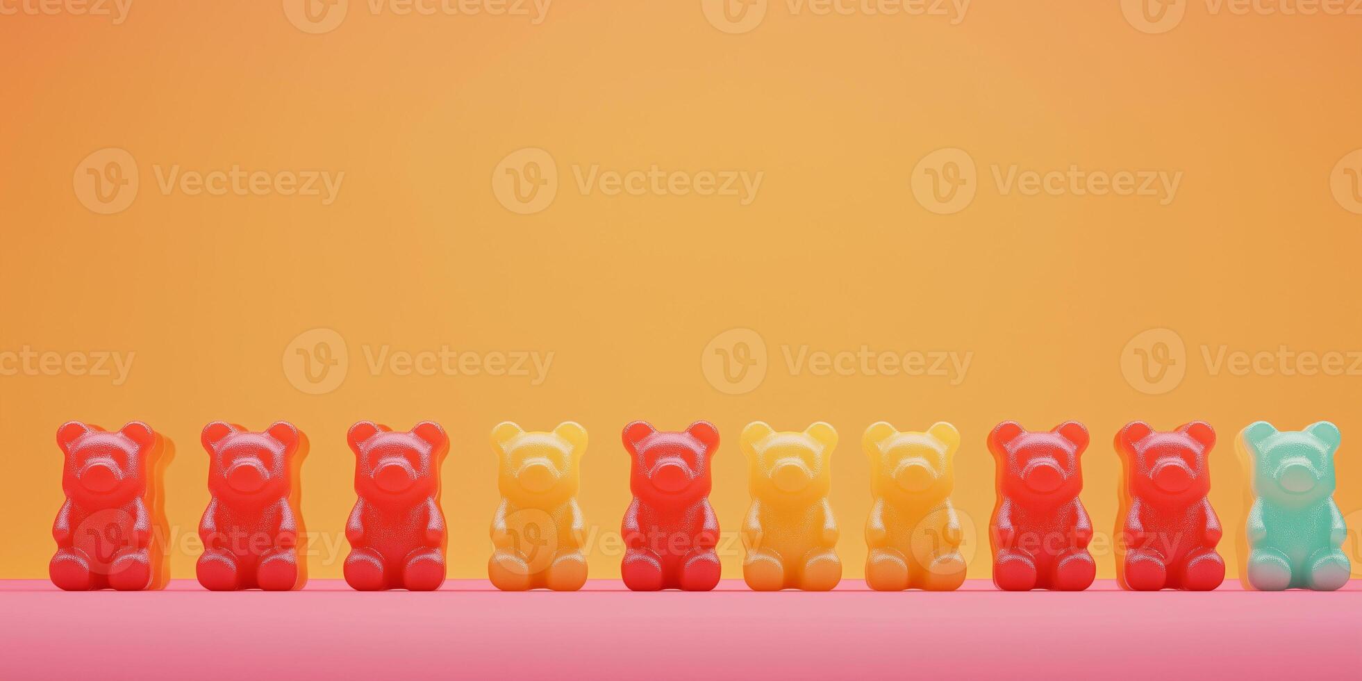Candy pieces shaped like miniature bears lined up in rows on a surface photo