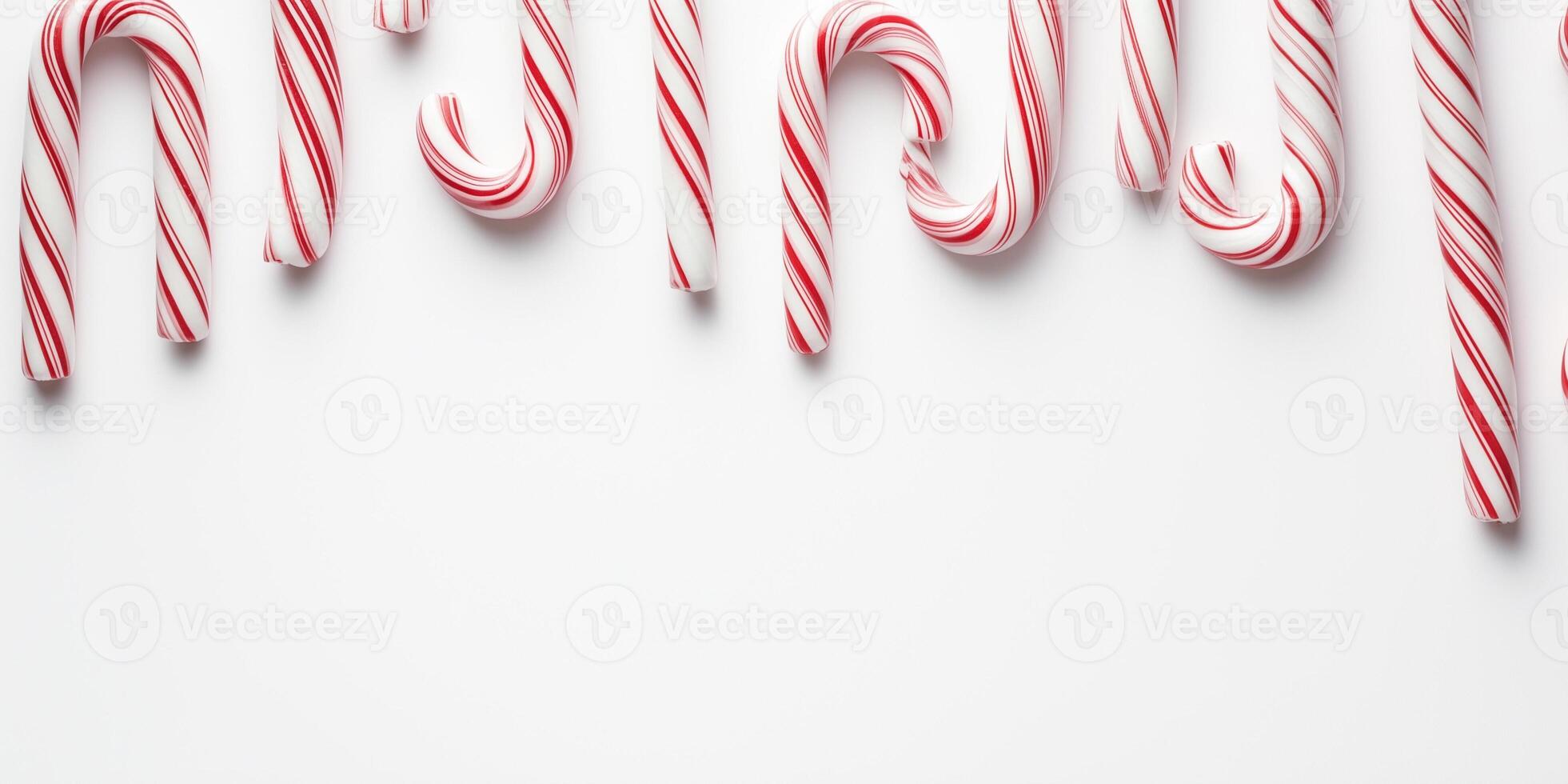 Candy canes of varying lengths form a zig-zag pattern across the top border photo