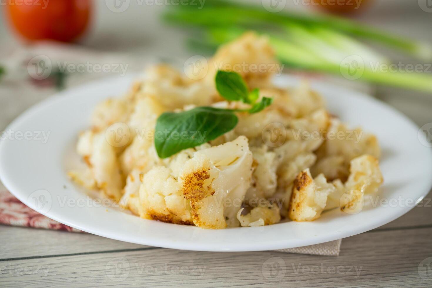 fried diet cauliflower cooked in a plate on a wooden table photo