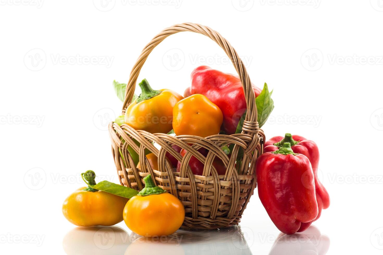 ripe red and yellow sweet peppers. Isolated on white photo