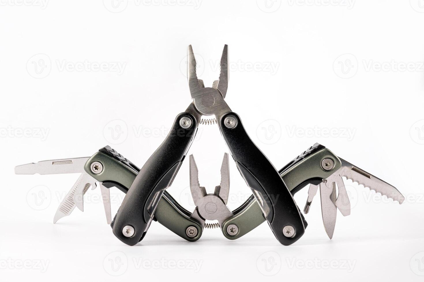 Steel multitool isolated on white background. Opened multitool with pliers, file, blade, screwdriver, bottle opener and saw, with a white background. Multi tool with expanded tools and pliers photo