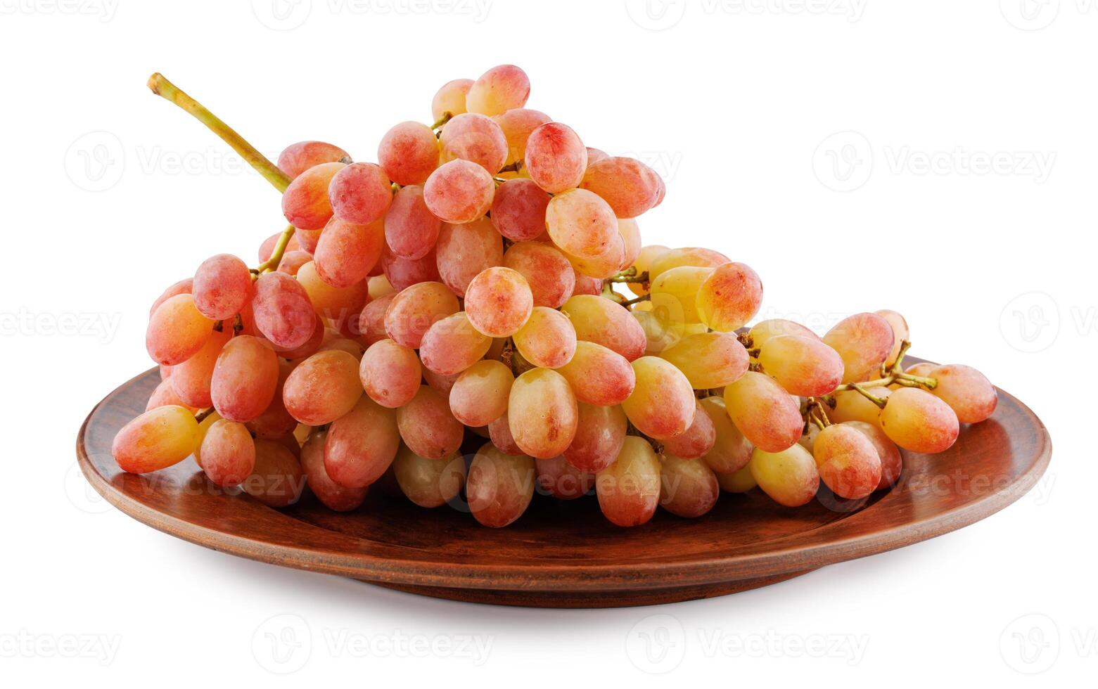 Juicy beautiful bunch of grapes lying in a clay plate isolated on a white background. photo