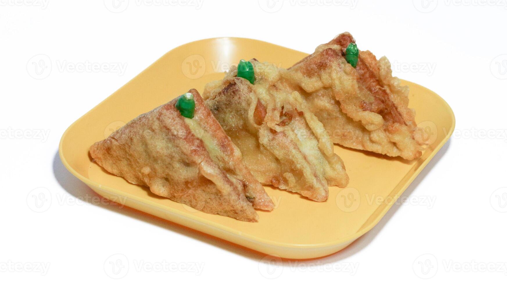 Roti Goreng is common fritter snack in Indonesia which made of white bread filled with creamy chicken and vegetable. photo