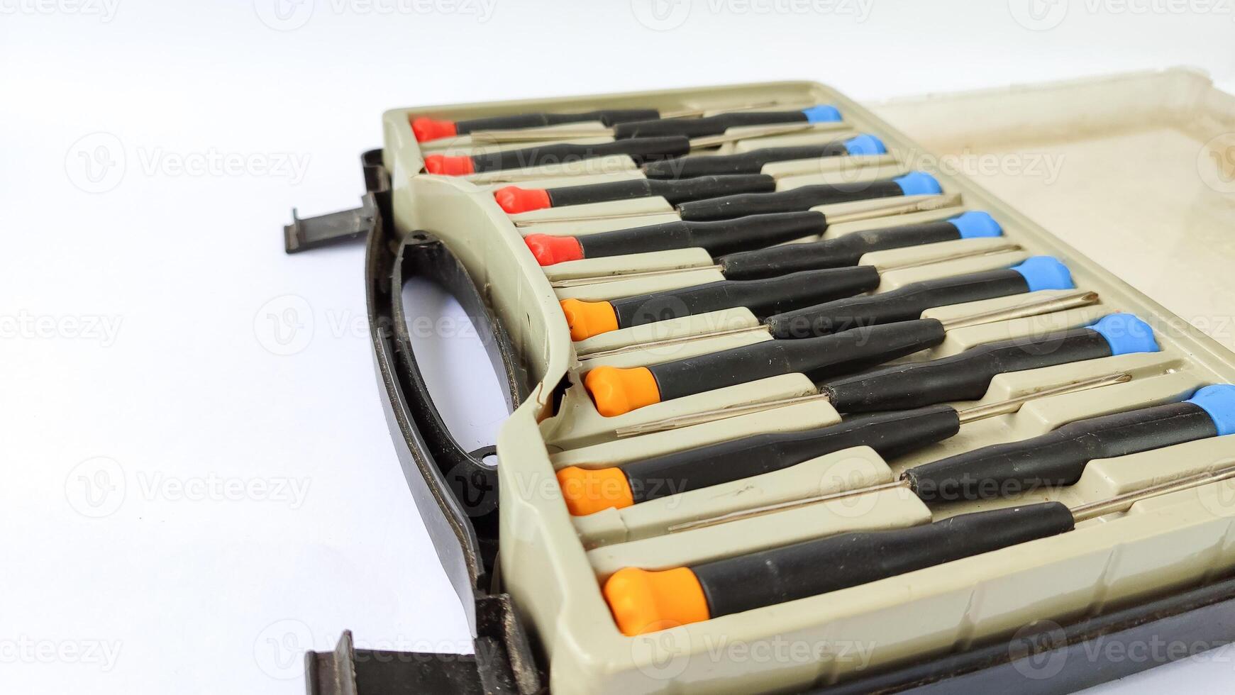 Set of red-orange-blue screwdrivers isolated on white background. Builder's and electrician's tools. Equipment. Set of steel screwdriver bits with red and black plastic handles. photo