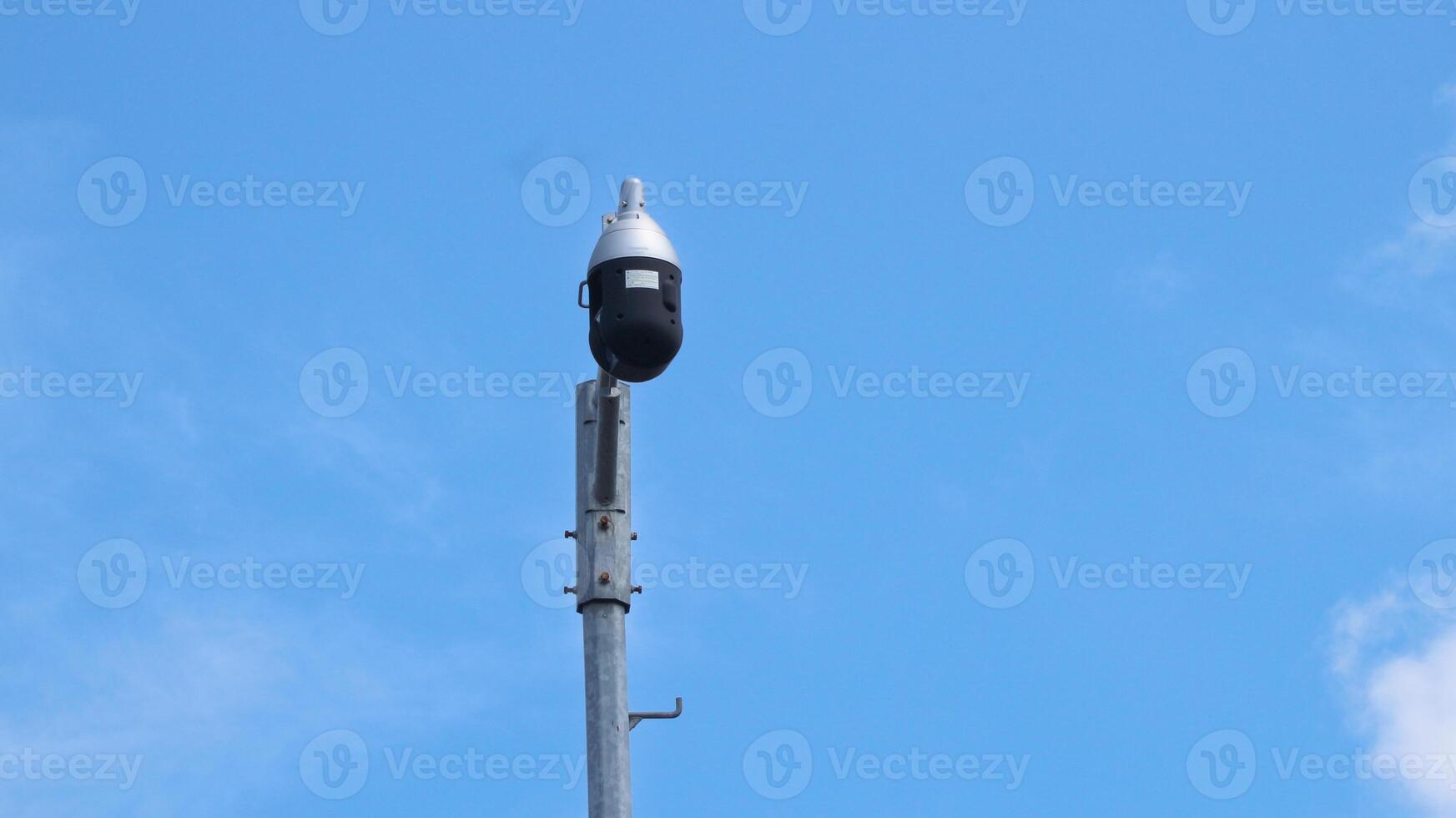 Three CCTV cameras and and an autonomous lighting system based on an LED lamp are installed on pole located on city street photo