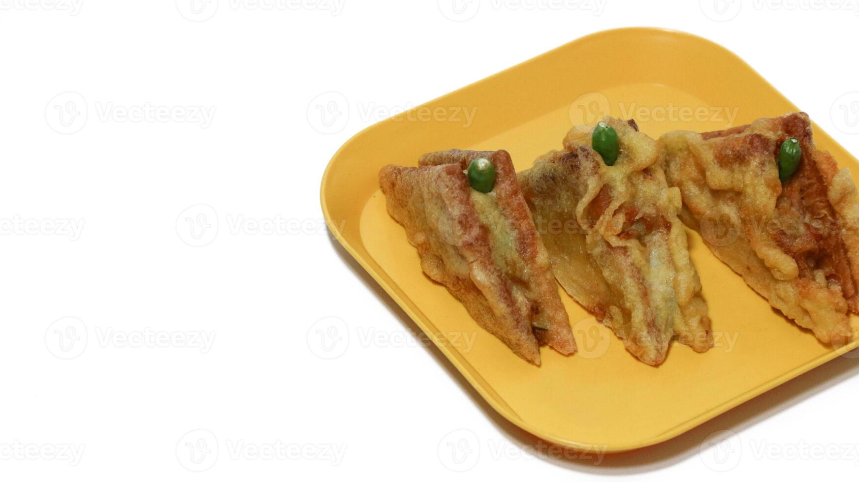 Roti Goreng is common fritter snack in Indonesia which made of white bread filled with creamy chicken and vegetable. photo