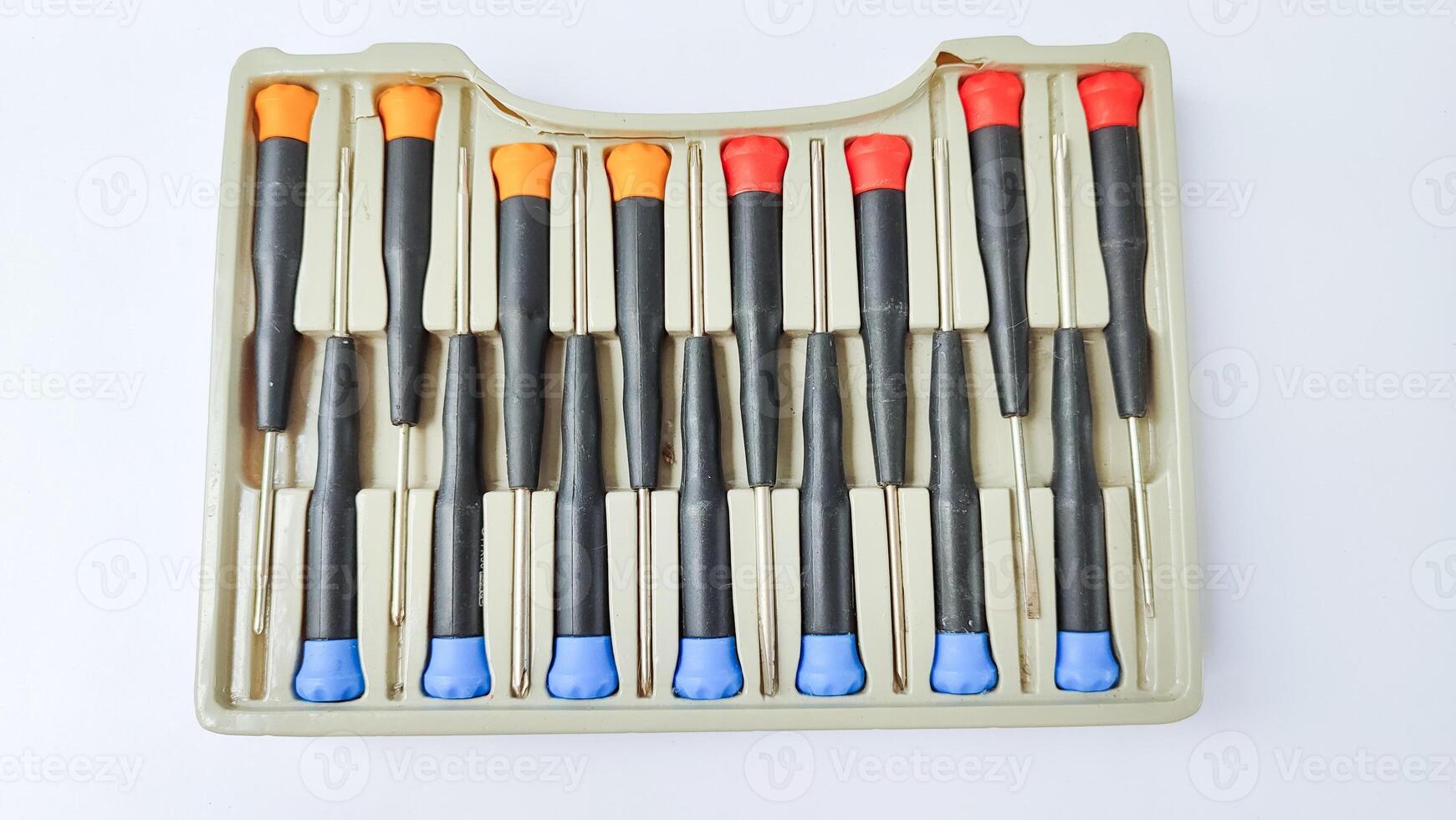 Set of red-orange-blue screwdrivers isolated on white background. Builder's and electrician's tools. Equipment. Set of steel screwdriver bits with red and black plastic handles. photo